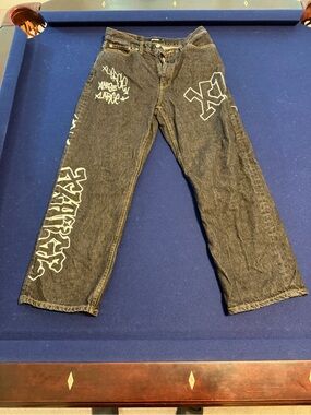 Relaxed Black Men's Jeans with White Graffiti Accents